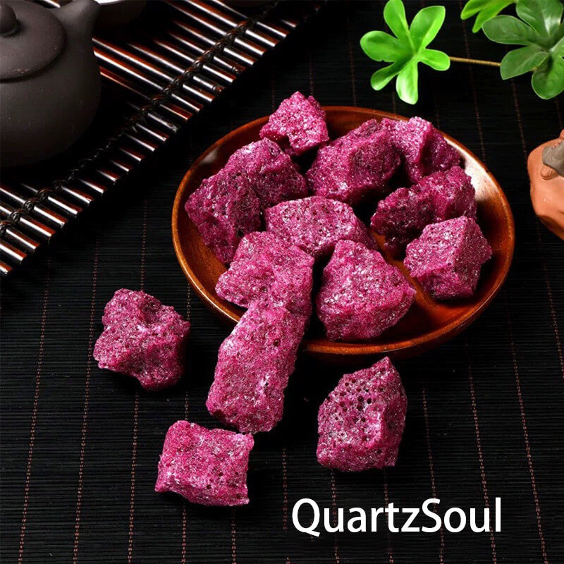Natural raw red corundum crystals in a wooden bowl with tea ceremony setting