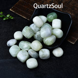 New Mountain Jade tumbled stones arranged in a black bowl showing their smooth polished finish