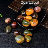 Collection of polished Ocean Jasper tumbled stones displayed in black bowl