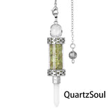 Olivine crystal pendulum with natural stone fragments in transparent chamber