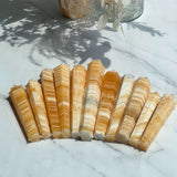 Banded Orange Calcite Tower in meditation space for crystal healing properties