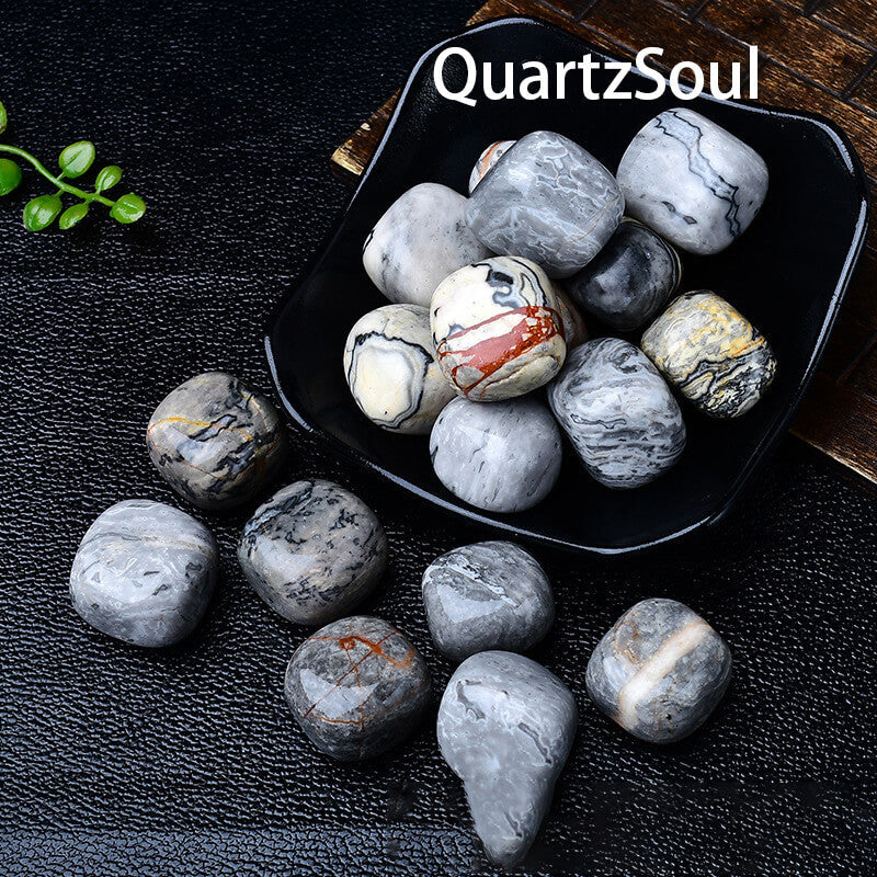 Polished Picasso Jasper tumbled crystals displayed in black bowl showing unique patterns