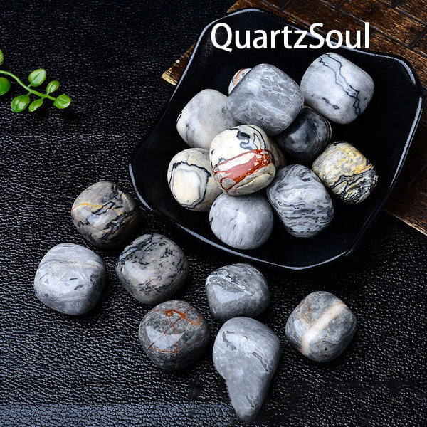 Polished Picasso Jasper tumbled crystals displayed in black bowl showing unique patterns