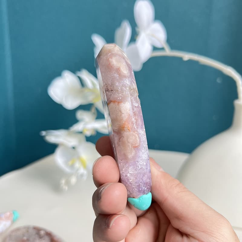 Pink amethyst whale crystal carving held in palm showing size