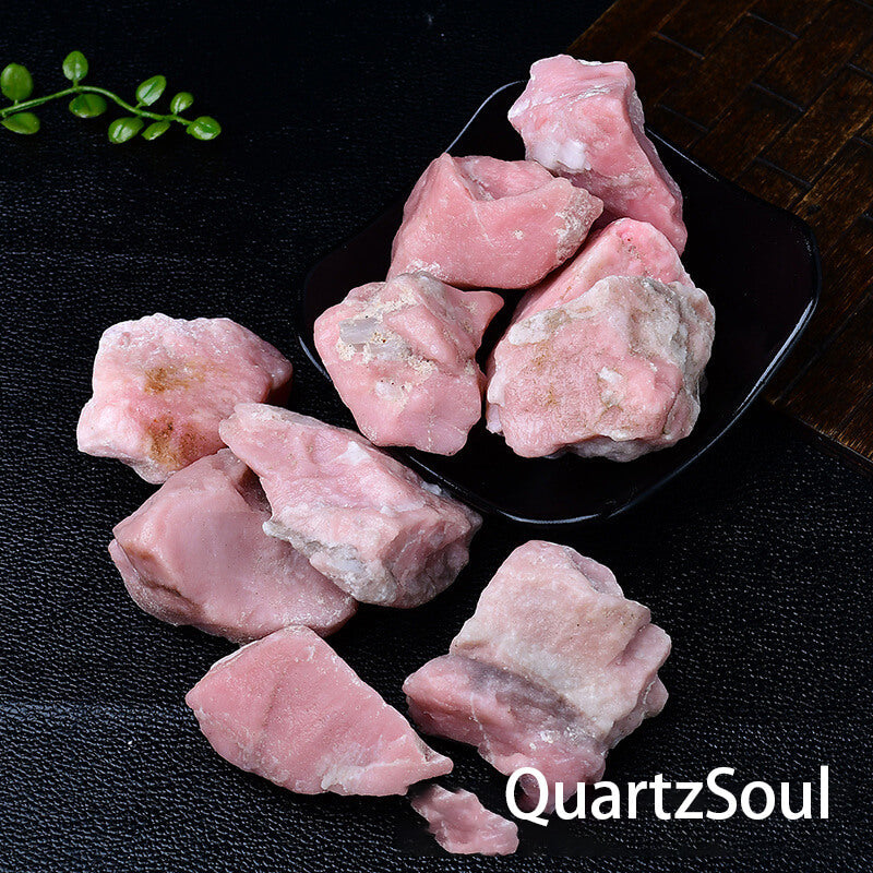 Pink opal healing crystals in natural raw form with white veining