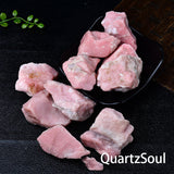 Pink opal healing crystals in natural raw form with white veining