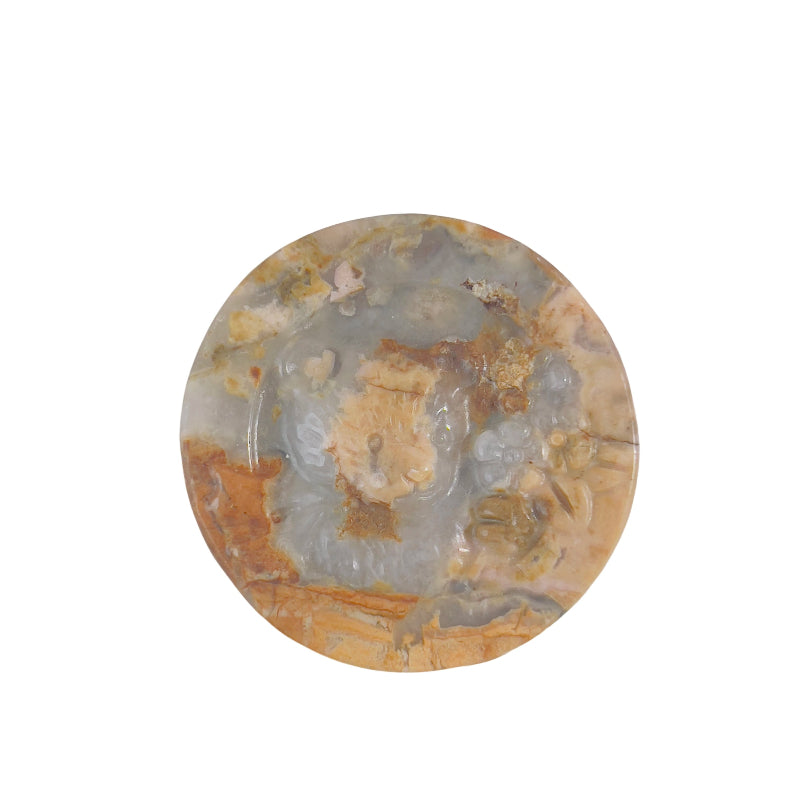 Close-up detail of pink and black patterns in natural rhodonite bear sculpture