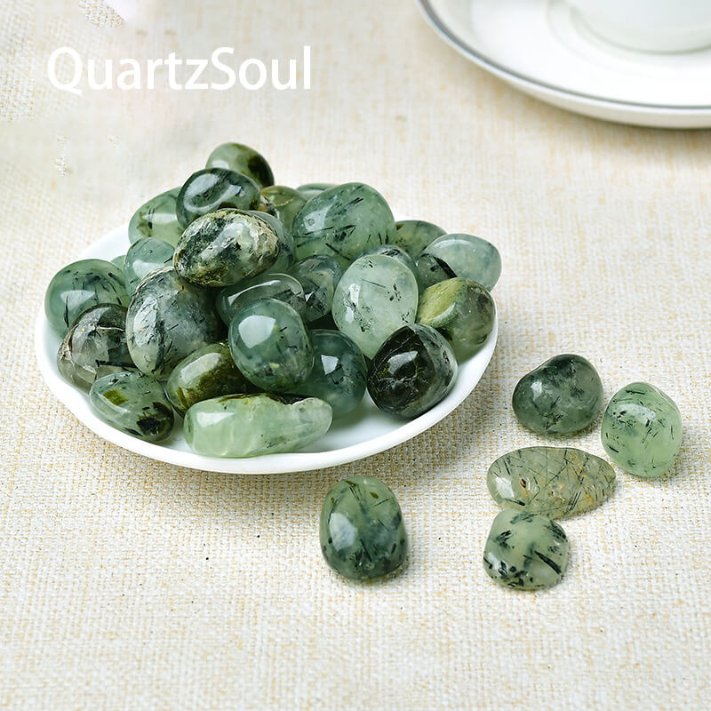 Collection of polished Prehnite tumbled stones showcasing various shades of green healing crystals