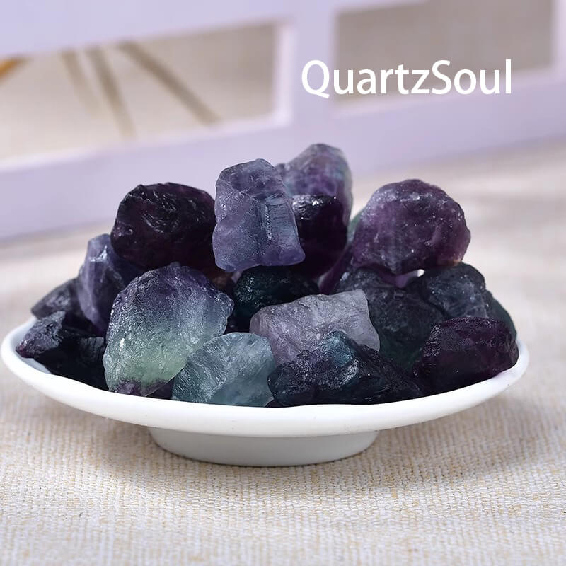 Mixed fluorite raw crystals in bowl display showing vibrant color variations