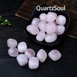Premium quality rose quartz tumbled stones displayed in black bowl showing 2-3cm size and translucent pink hue