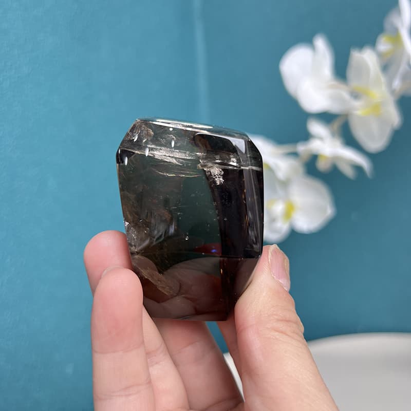 Smoky quartz free form with light reflection showing internal clarity
