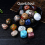 Collection of premium tumbled crystal stones displayed in decorative black bowl