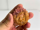 Angled view of rhodonite cabochon showing magical girl carving details