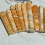 Close-up of Banded Orange Calcite Tower base with natural crystal formation