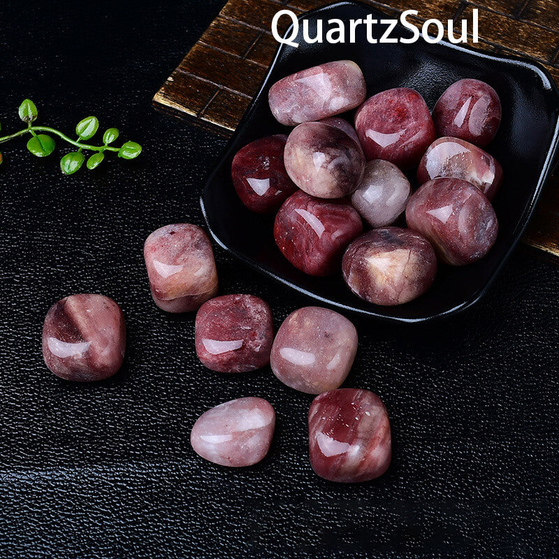 Natural Purple Aventurine tumbled stones in black display bowl with green plant accent