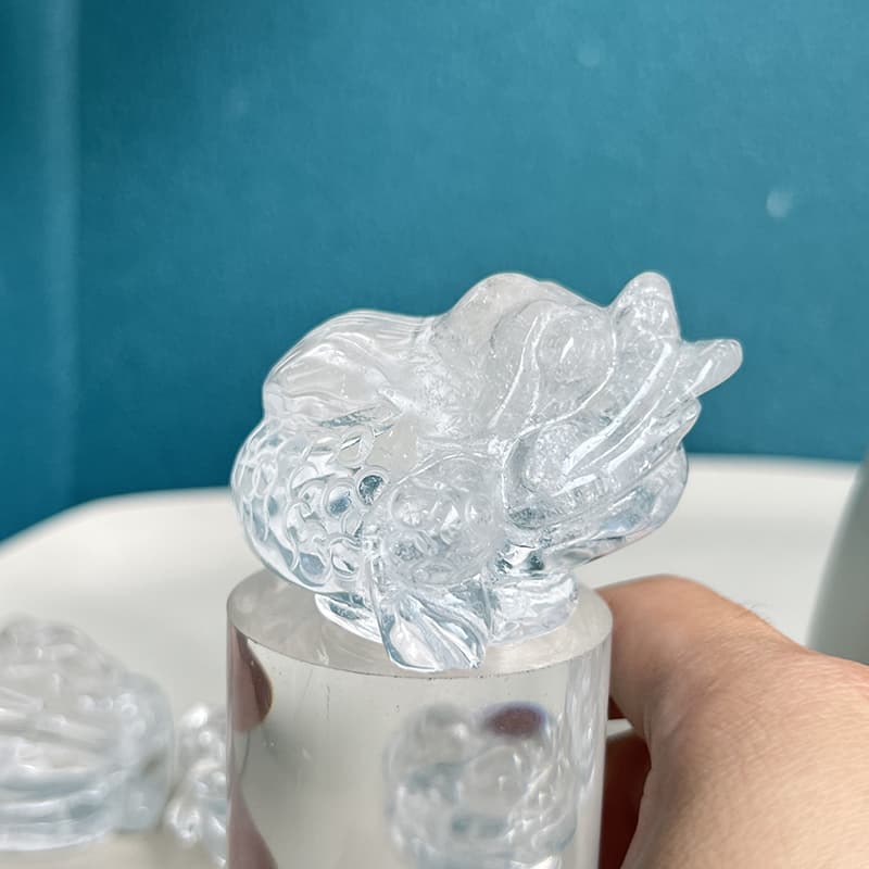 Side angle view of hand carved quartz crystal toad