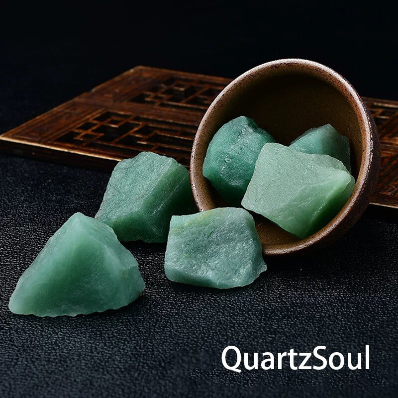 Natural raw green aventurine crystal stones in ceramic bowl on wooden display