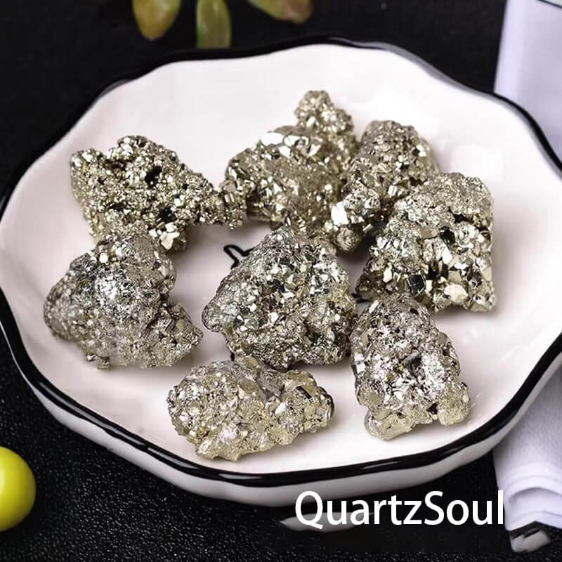 Raw pyrite stone specimens displayed on white plate