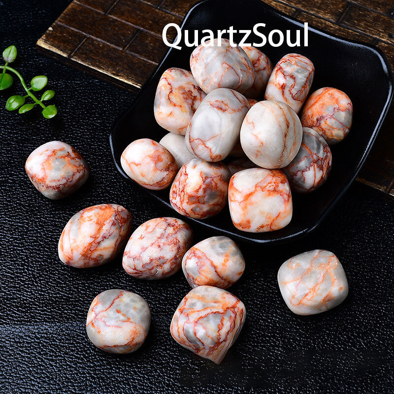 Premium Red Agate tumbled gemstones displayed in black bowl