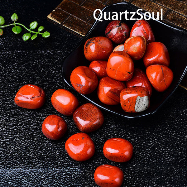 Premium Red Jasper tumbled stones displayed in a black bowl highlighting their healing properties