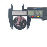 Side view of handcrafted rhodonite crystal bear showing natural veining