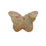 Side angle view of rhodonite butterfly crystal carving showing dimensional details