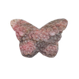 Close up of rhodonite butterfly crystal carving showing detailed pink crystal formations