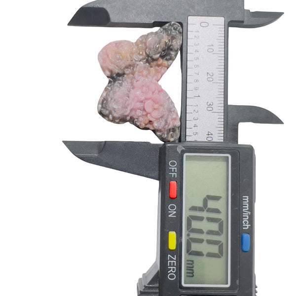 Pink rhodonite butterfly crystal sculpture displayed