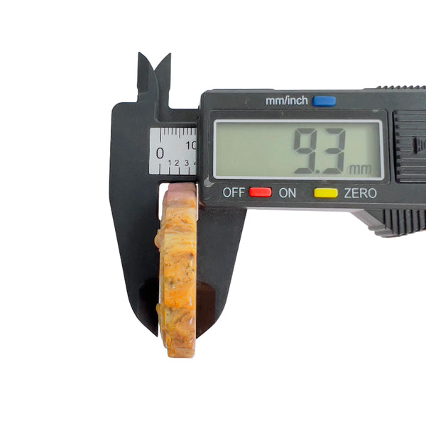Pink rhodonite crystal thickness measurement showing 9.3mm