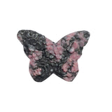 Palm-sized pink rhodonite butterfly carving highlighting the stone's natural beauty