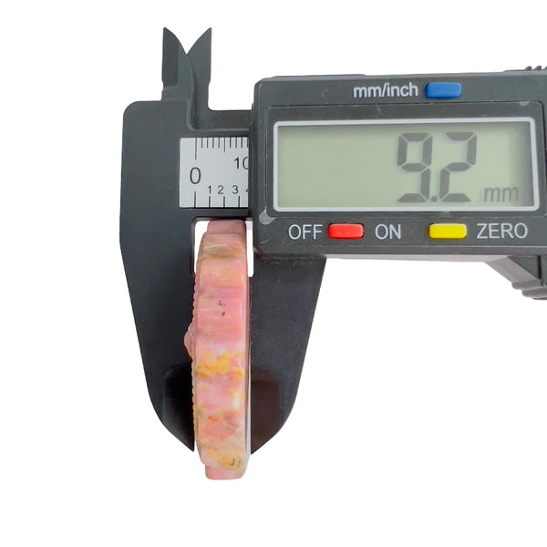 Pink rhodonite stone thickness measurement with digital caliper