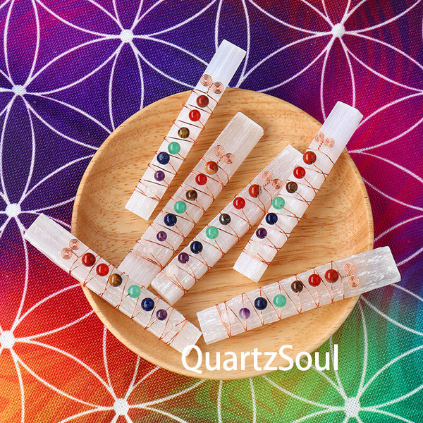 Selenite wand in hand showing scale and smooth surface texture