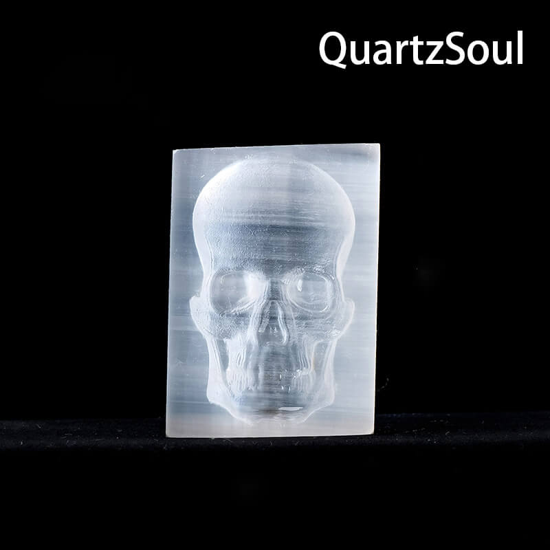 Natural white selenite crystal skull palm stone with translucent glow