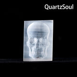 Natural white selenite crystal skull palm stone with translucent glow