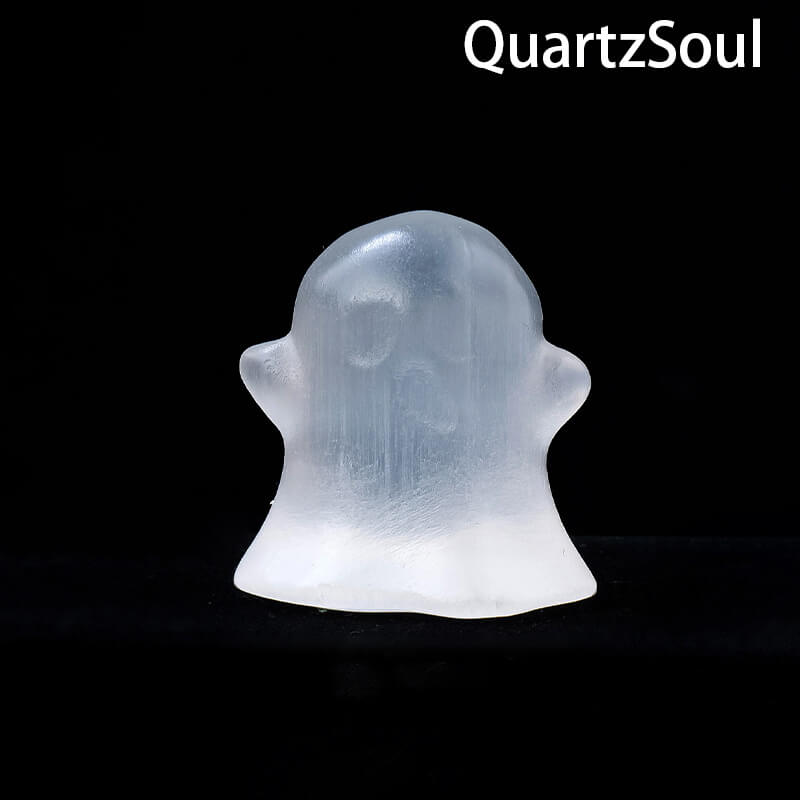 Selenite ghost crystal palm stone displayed with other healing crystals