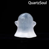 Selenite ghost crystal palm stone displayed with other healing crystals