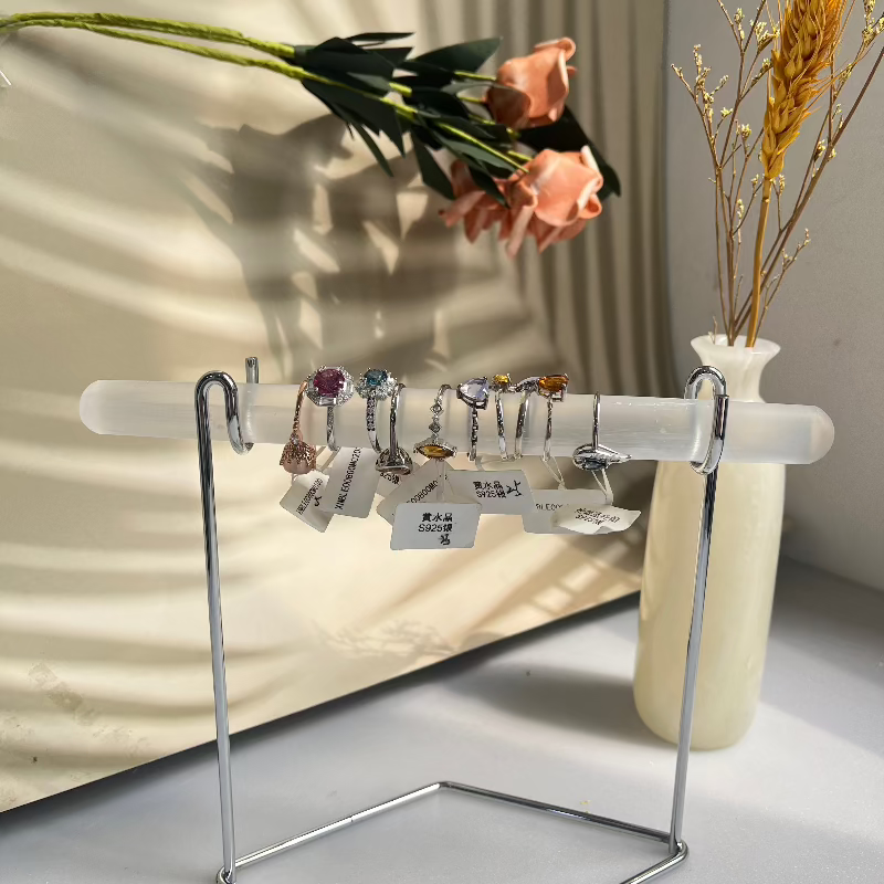 White selenite crystal jewelry display with multiple rings