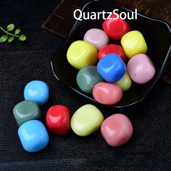 Smooth tumbled gemstones collection displayed in a decorative bowl showcasing vibrant colors