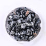 Collection of Snowflake Obsidian tumbled stones in white ceramic bowl showing various sizes