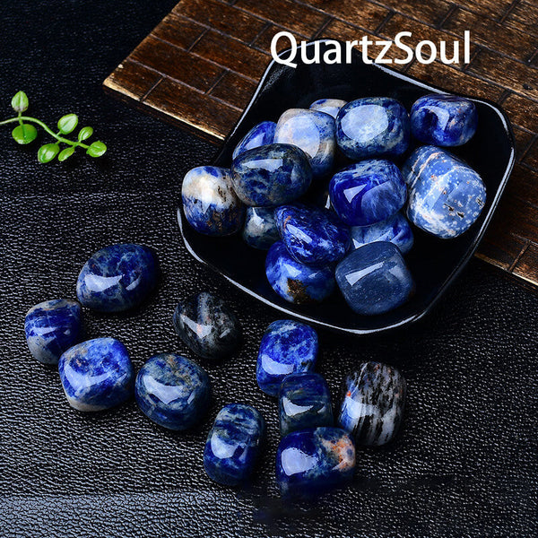 Sodalite tumbled stones displayed in black bowl for crystal healing
