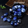 Sodalite tumbled stones displayed in black bowl for crystal healing