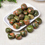 Collection of polished Unakite tumbled gemstones in white dish for crystal healing