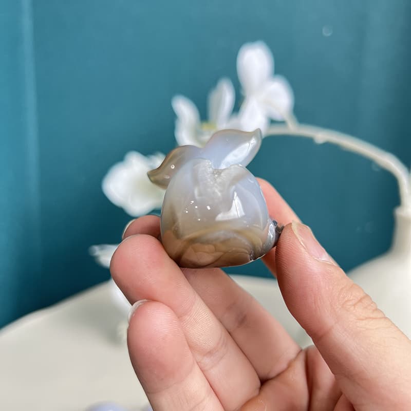 Close-up detail of handcrafted white agate dolphin crystal carving
