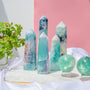 Natural fluorite crystal tower with vibrant green and purple banding