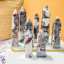 Natural moss agate crystal point with green and white swirling patterns