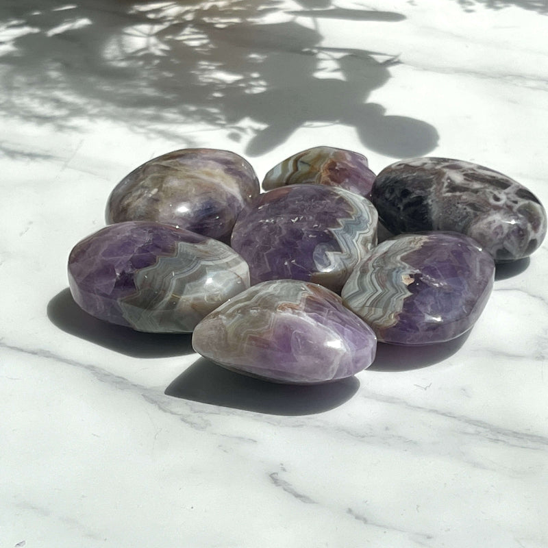 Chevron Amethyst Palm Stone Being Used for Hand Healing Therapy