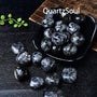 Natural Black Tourmaline tumbled stones with white streaks in decorative bowl