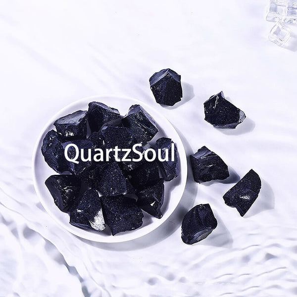 Natural raw Blue Sandstone crystal pieces in white bowl showing sparkling midnight blue color and texture