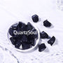 Natural raw Blue Sandstone crystal pieces in white bowl showing sparkling midnight blue color and texture