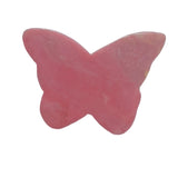 Pink rhodonite butterfly crystal carving in meditation altar setup for emotional healing